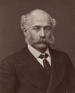 Portrait photograph of Joseph Bazalgette, the Victorian civil engineer behind London’s modern sewer system, showing him in formal suit with thick sideburns and mustache, facing the camera against a plain background.